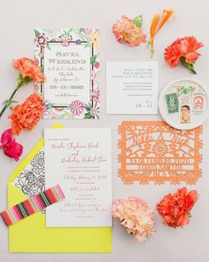 the wedding stationery is laid out with flowers and other things to put on it