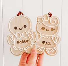 someone holding two wooden cutouts that say happy and aria