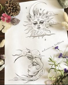 two sun and moon drawings on paper next to flowers