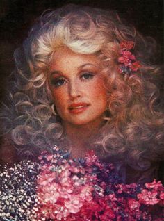 an old photo of a woman with blonde hair and pink flowers in her hair,