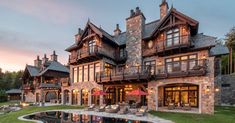 a large house with a pool in front of it