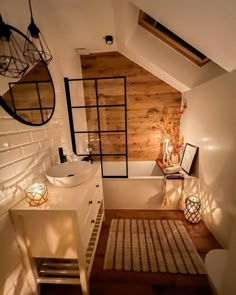 an attic bathroom with wooden walls and white fixtures, along with a rug on the floor