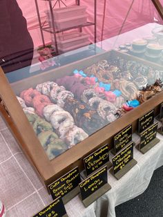 a display case filled with lots of different types of donuts