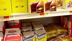 shelves in a grocery store filled with donuts