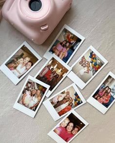 several polaroid photos and a pink camera on the floor