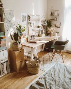 a room with a desk, chair and bookshelf filled with various items in it