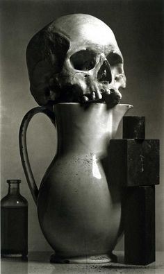 a skull sitting on top of a pitcher