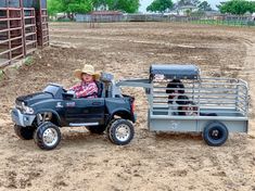 a little boy driving a toy truck in the dirt