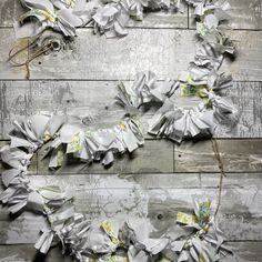 some white and yellow flowers on a wooden floor with grey paint peeling off the wall