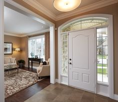 a living room filled with furniture and a white door