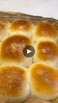 bread rolls in a basket on top of a table