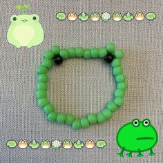 a green beaded bracelet with a frog on the front and two smaller beads in the back