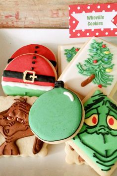 decorated cookies in the shape of christmas trees and santa hats