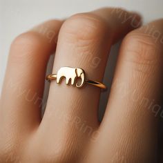 *Free engravings up to 20 characters* Discover the enchantment of the savanna with this exquisite Elephant ring! 🐘✨ Each piece is a tribute to these majestic creatures, symbolizing strength and wisdom. Whether you're a wildlife enthusiast or adore unique jewelry, this ring is a perfect choice. Crafted with precision, they're available in sterling silver, solid 10k yellow gold, rose gold, or white gold, ensuring there's a style to suit every preference. The elegant design captures the essence of the elephant in a minimalist yet captivating manner, making them versatile for daily wear or special occasions. These Elephant Earrings aren't just accessories; they're a celebration of nature's beauty and the awe-inspiring presence of African wildlife. They're ideal for gifting to those who cheris African Rings, Elephant Ring Gold, Gold Finger Rings, Buy Gold And Silver, Elephant Ring, Elephant Jewelry, Gold Elephant, Elephant Earrings, Elephant Lover