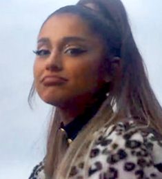 a close up of a person with long hair and wearing a leopard print jacket,