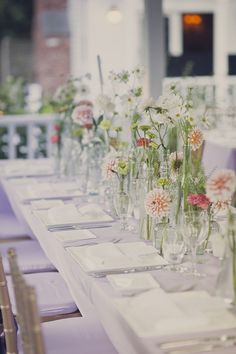 the table is set with silverware and flowers