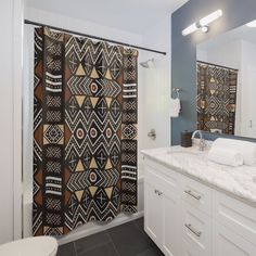 a bathroom with a shower curtain, sink and toilet in the background is a blue wall