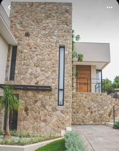 a house with stone walls and green grass