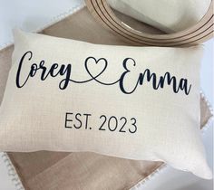 a personalized pillow with the name and date on it, next to a mirror