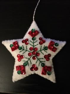 a white christmas ornament with red and green decorations