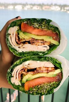 two wraps filled with meat, lettuce and avocado on top of each other