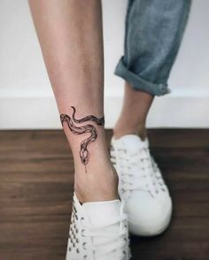 a woman's foot with a tattoo on her left leg and an octopus tattooed on the ankle