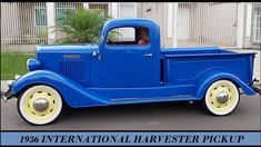 an old blue truck parked in front of a house