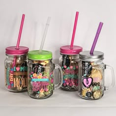 three mason jars filled with candy and drinking straws