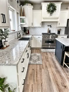 a kitchen with white cabinets and wood floors is featured in the instagramm post