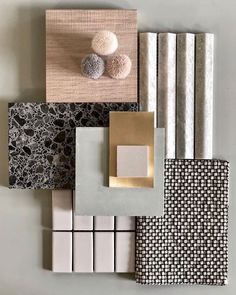 an assortment of different colors and patterns on the wall with white, black, gold, and grey tiles