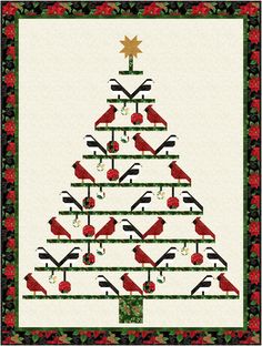 a quilted christmas tree with red birds on the top and green trimmings