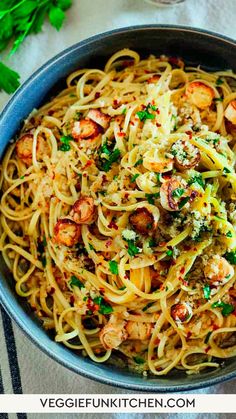 pasta with shrimp and parsley in a blue bowl