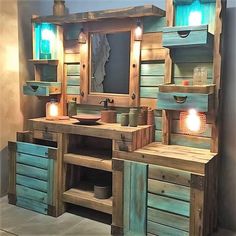 a bathroom with wooden cabinets and lights on the mirror above the sink is made out of pallet wood