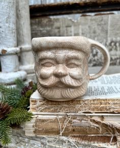 a coffee cup sitting on top of an old book