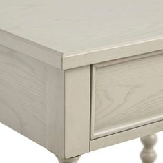 a white table with two drawers on one side and an open drawer on the other