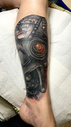 a man's leg with a tattoo on it that has an image of a helmet