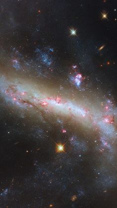 an image of a spiral galaxy with stars in the sky and bright lights on it