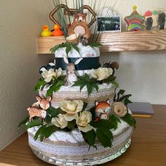 a three tiered cake decorated with flowers and stuffed animals