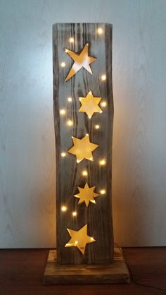 a wooden block with stars on it and some lights in the shape of an arrow