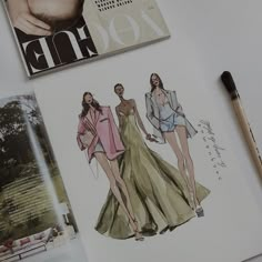 an open magazine with two women's clothes on it and a pen next to it