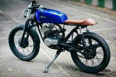 a blue and black motorcycle parked in a parking lot