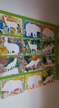 an art project is displayed on the wall, with animals painted on it's sides