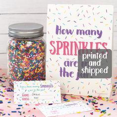 sprinkles are in a jar next to a card