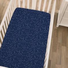 a baby crib with a blue blanket on it