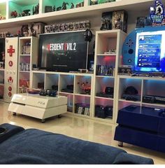 a living room filled with furniture and a flat screen tv sitting on top of a book shelf