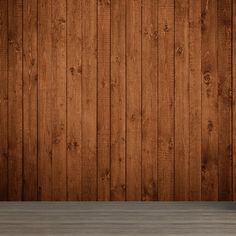 an empty table in front of a wooden wall