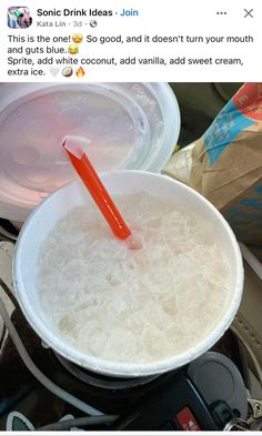 a plastic cup filled with ice and water next to a paper bag on top of a scale