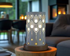 a lit candle sitting on top of a wooden table in front of a living room