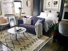 a living room filled with furniture and decor on top of a hard wood floored floor