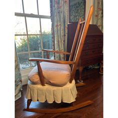 a rocking chair in front of a window